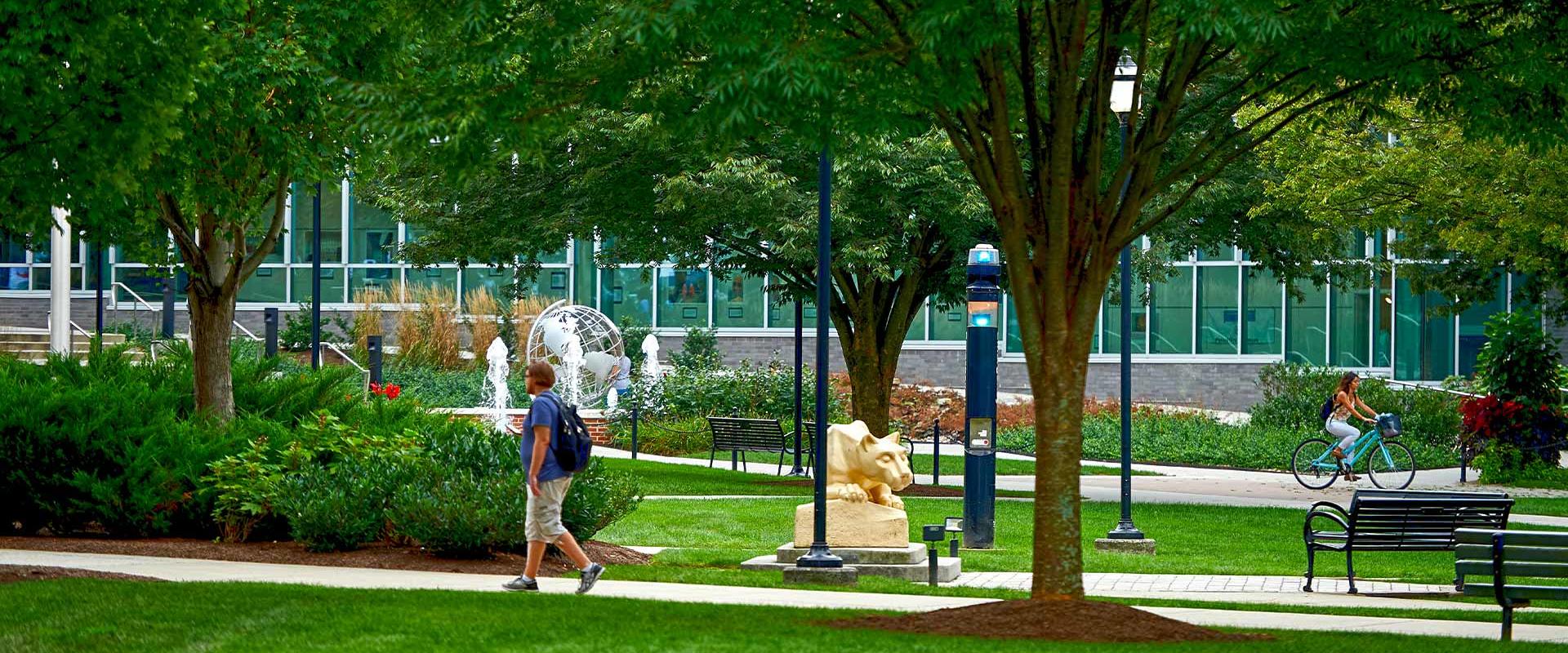 Outdoor scene of students walking past Nittany Lion Shrine at Penn State Harrisburg
